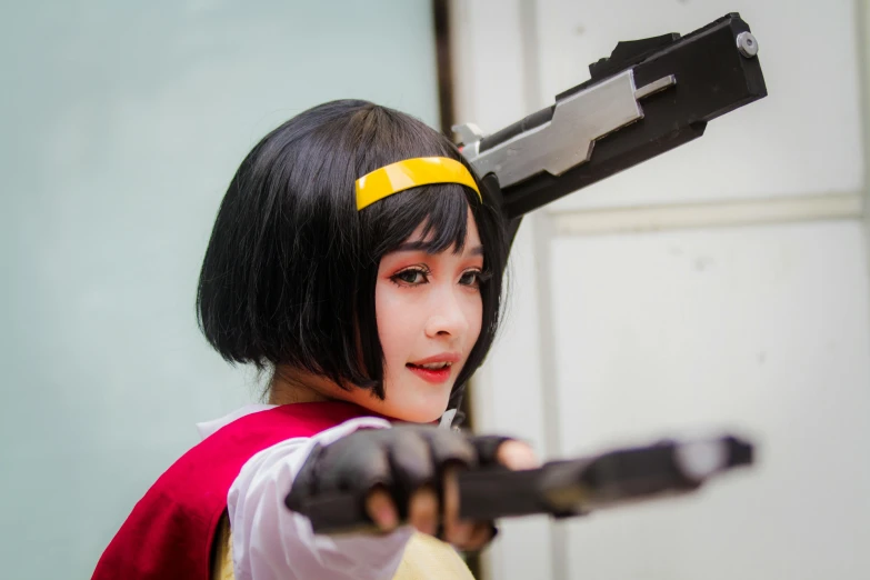 a close up of a person holding a gun, inspired by Leng Mei, wearing red and yellow hero suit, cosplay photo, holding a sword on her shoulder, instagram photo