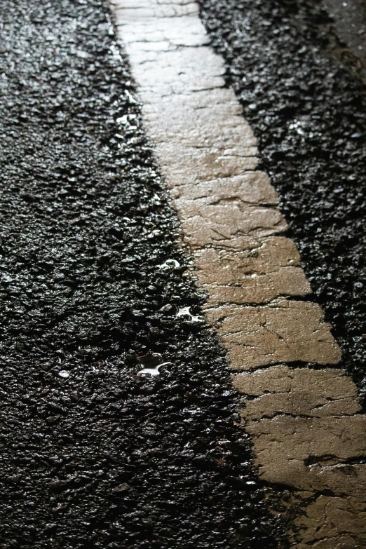 a yellow fire hydrant sitting on the side of a road, an album cover, unsplash, photorealism, close-up print of fractured, paved roads, paul barson, made of tar