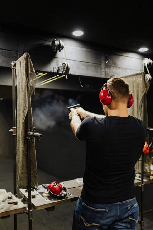 a man shooting with a gun in a shooting range, pexels contest winner, renaissance, smoke filled room, in australia, backroom background, performance