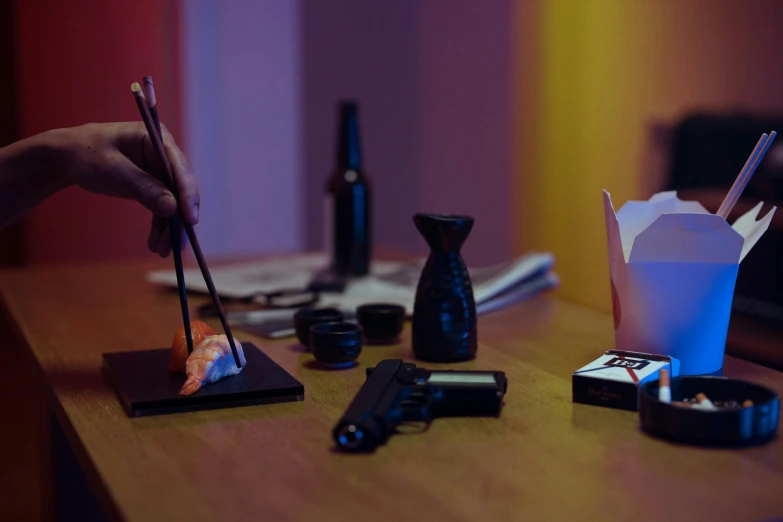 a person holding chopsticks on top of a wooden table, a still life, inspired by Liam Wong, gunfire, ( ( theatrical ) ), sushi, neon noir