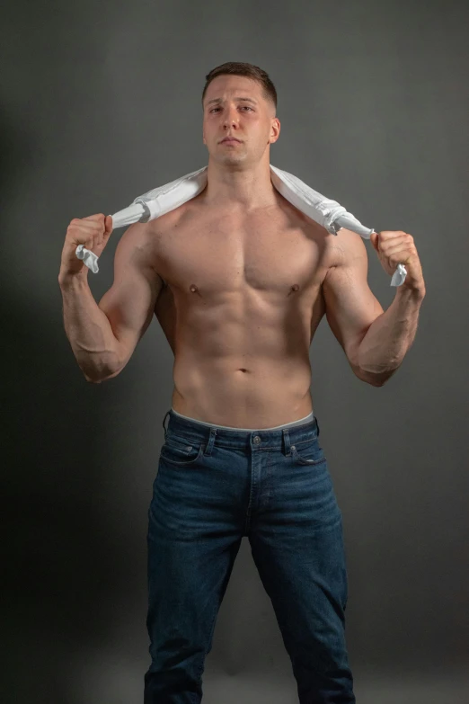 a shirtless man holding a baseball bat over his shoulder, inspired by Ryan Pancoast, white shirt and blue jeans, wearing a towel, photograph taken in 2 0 2 0, muscular! white