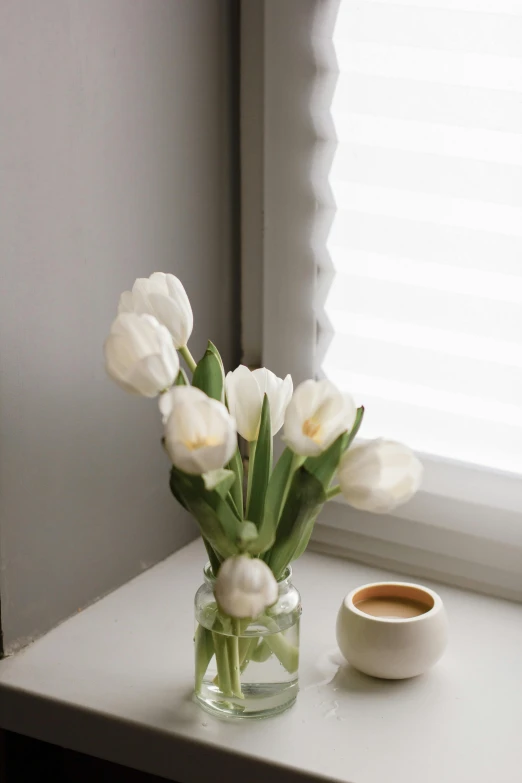 a vase filled with white flowers next to a cup of coffee, inspired by jeonseok lee, romanticism, tulip, natural window lighting, soft vibes, snacks
