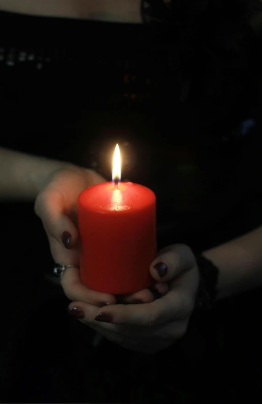 a woman holding a red candle in her hands, by Linda Sutton, pixabay, a seance, instagram post, 15081959 21121991 01012000 4k, lgbtq