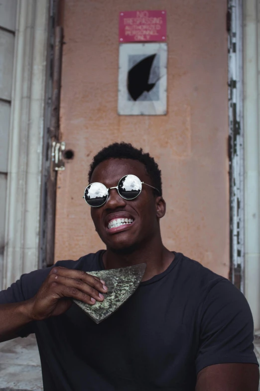 a man wearing sunglasses and a tie in front of a door, an album cover, by Stokely Webster, pexels contest winner, made of money, large black smile, yzy gap, trending on vsco