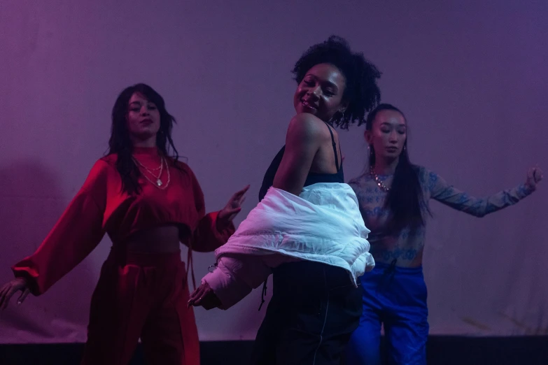 a group of women standing on top of a stage, unsplash, realism, dance party, still from a music video, studio shot, three women