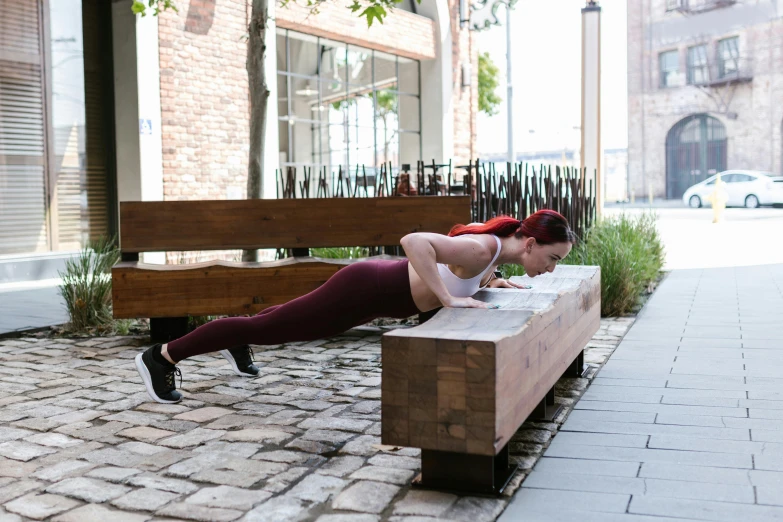 a woman is doing push ups on a bench, unsplash, square, long table, lachlan bailey, thumbnail