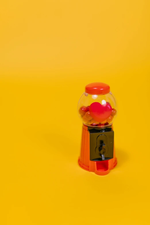a gummy machine on a yellow background, by Doug Ohlson, pexels contest winner, love theme, gumball machine, empty background, gif