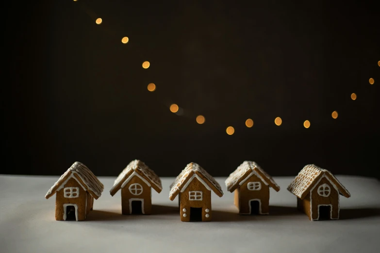 a group of ginger houses sitting on top of a table, unsplash, dark. no text, model photograph, mini model, lights off