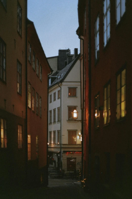 a couple of buildings that are next to each other, by Sigrid Hjertén, unsplash contest winner, tonalism, colonial era street, side lights, taken in the mid 2000s, swedish