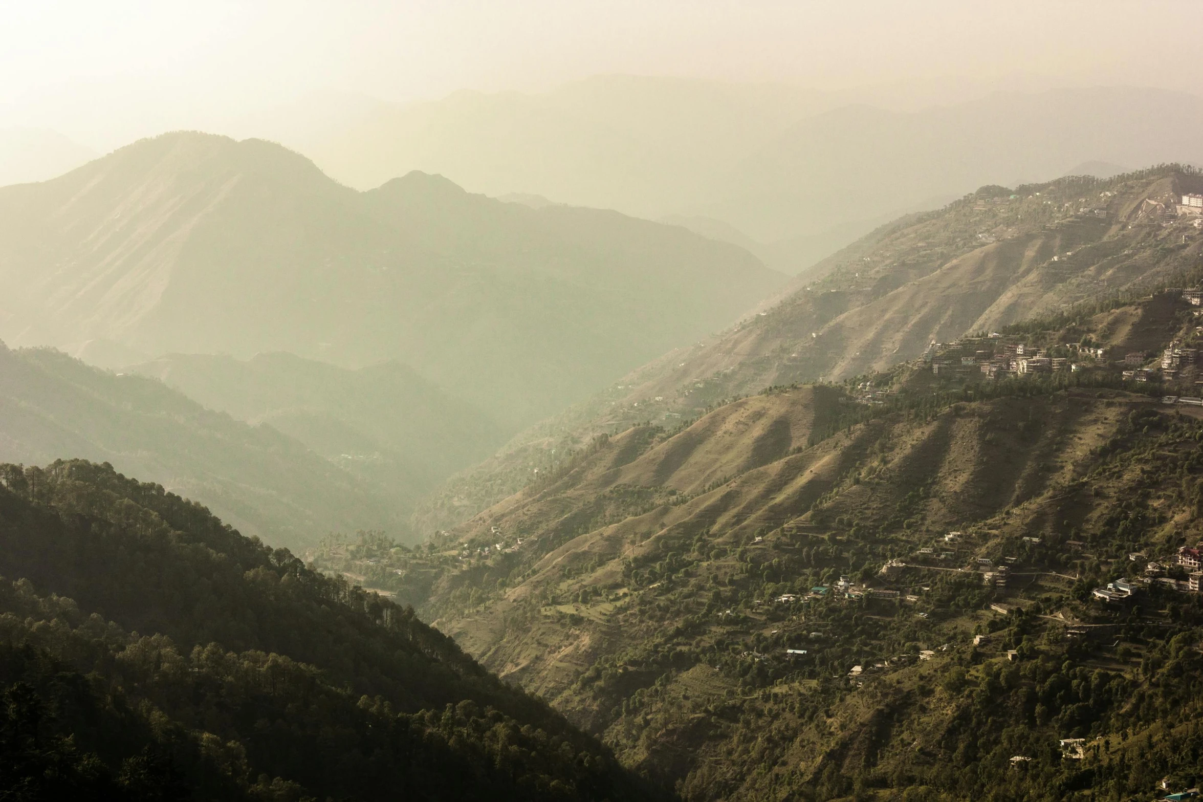 a view of a valley with mountains in the background, pexels contest winner, les nabis, uttarakhand, faded and dusty, sunny light, multiple stories