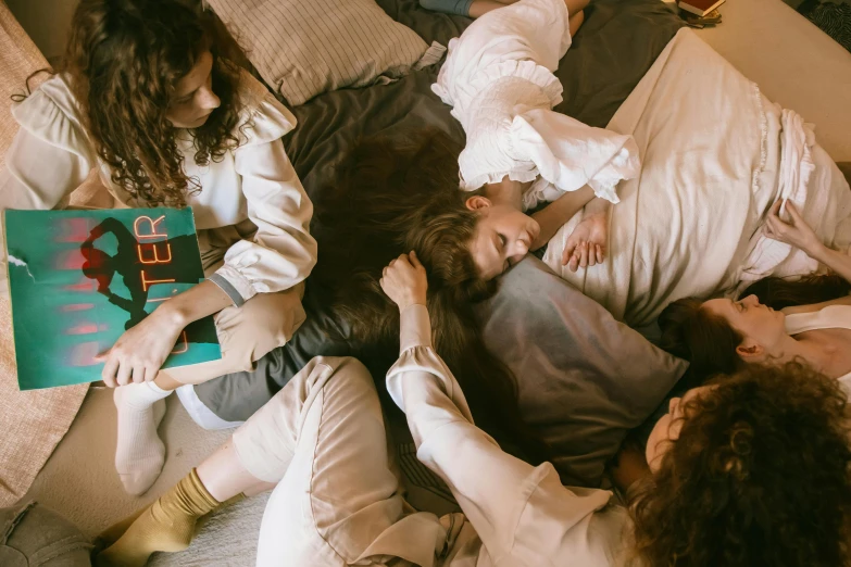 a group of people laying on top of a bed, by Emma Andijewska, pexels contest winner, three women, alana fletcher, ignant, accurate depiction