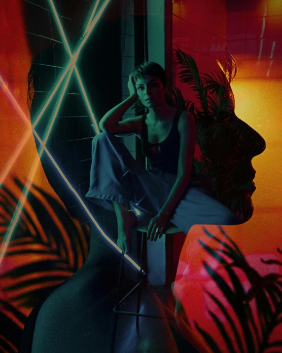 a woman sitting on top of a chair next to a plant, an album cover, unsplash contest winner, holography, glowing neon skin, steven klein, androgyny, tropics