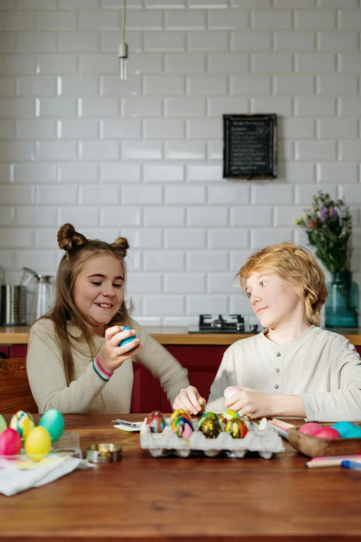 a couple of girls that are sitting at a table, pexels contest winner, process art, easter, boys, full product shot, indoor scene