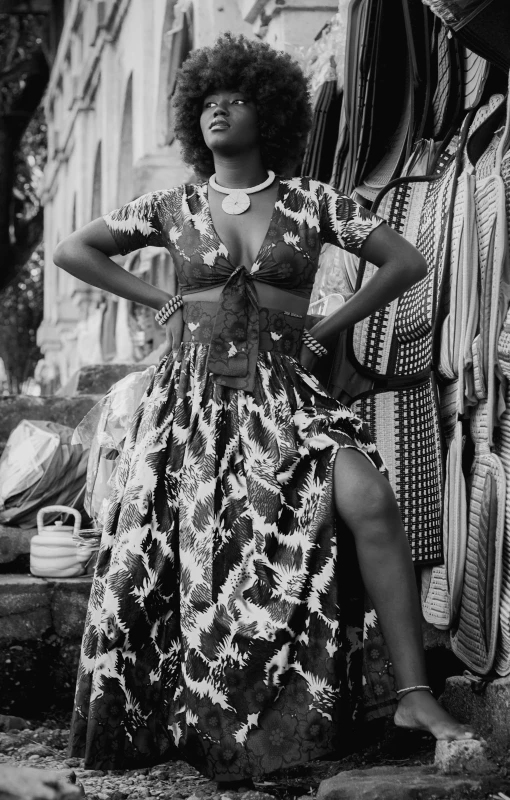 a black and white photo of a woman in a dress, flickr, afrofuturism, wide skirts, sza, african woman, in town