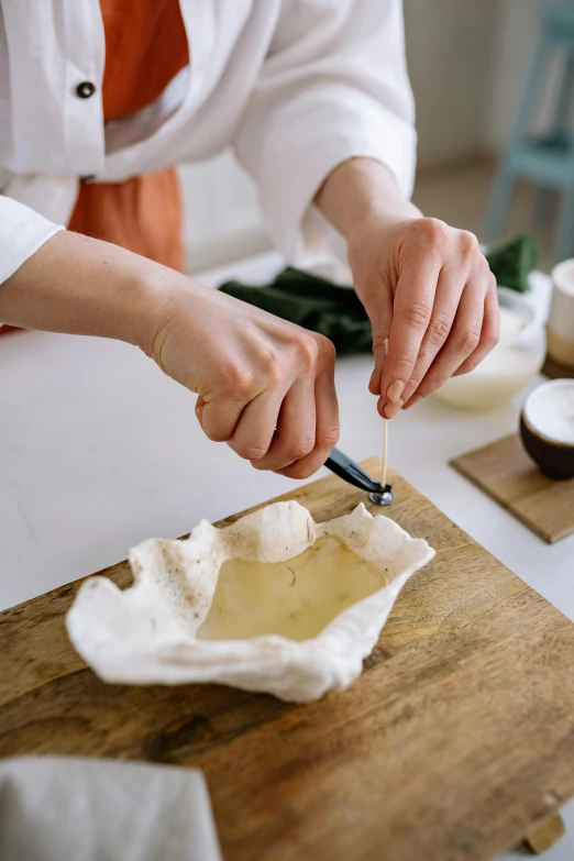 a close up of a person cutting food on a cutting board, a marble sculpture, conch shell, modelling, cooking, bowl