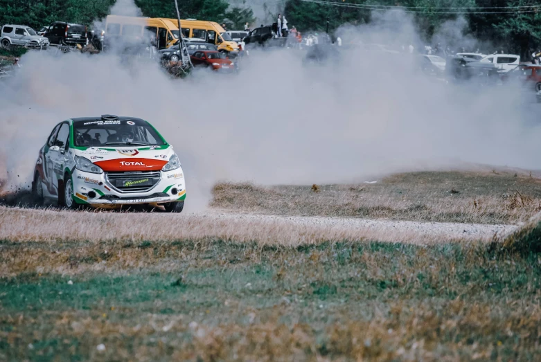 a rally car with a lot of smoke coming out of it, pexels contest winner, glass and metal : : peugot onyx, square, a green, gravels around