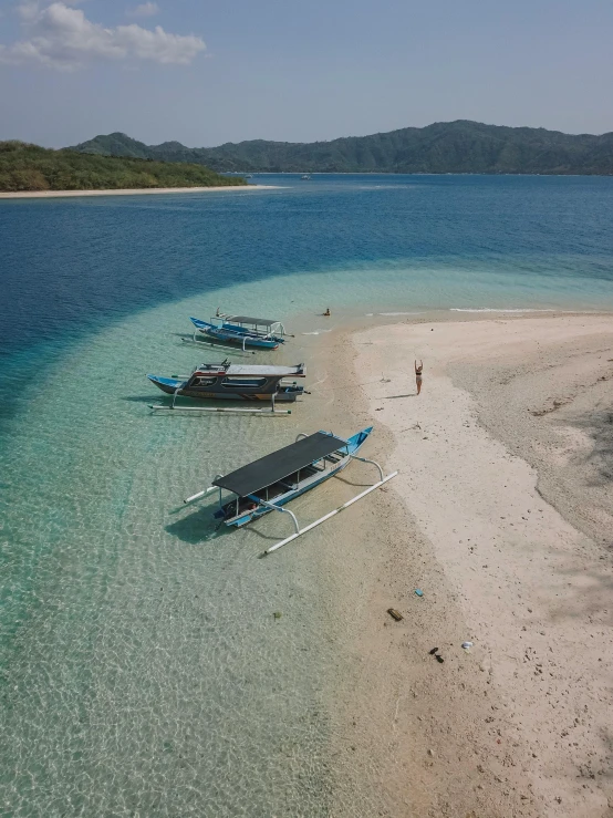 a couple of boats sitting on top of a sandy beach, an island, flatlay, ramil sunga, van