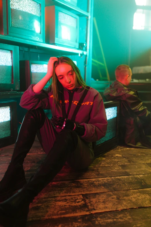 a woman sitting on the floor in front of a bunch of televisions, antipodeans, techwear clothes, sydney sweeney, promotional image, sitting sad in spaceship