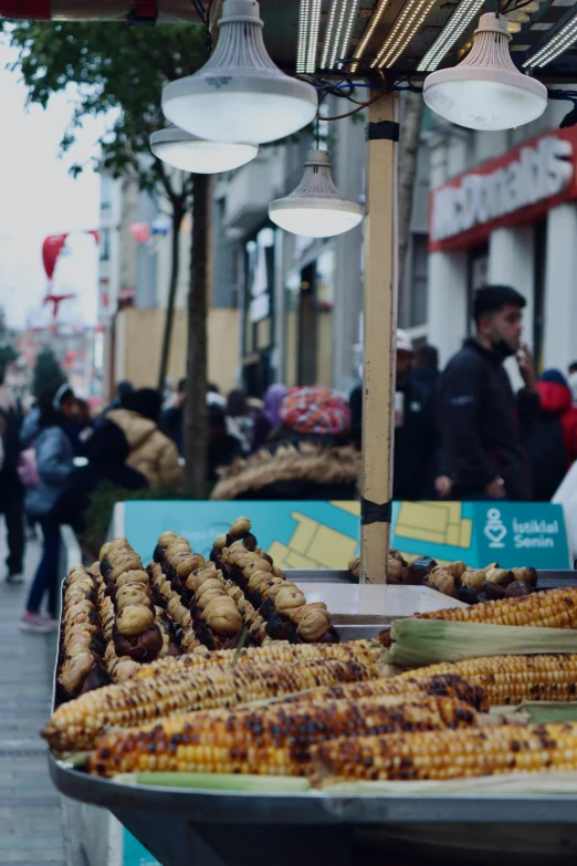 a street vendor selling corn on the side of the road, by Niko Henrichon, trending on unsplash, hurufiyya, istanbul, fresh bakeries in the background, 💋 💄 👠 👗, brown