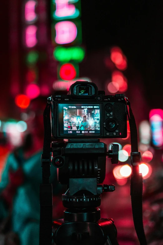 a camera that is sitting on a tripod, a picture, pexels contest winner, video art, hero pose colorful city lighting, back towards camera, red camera, blurry footage