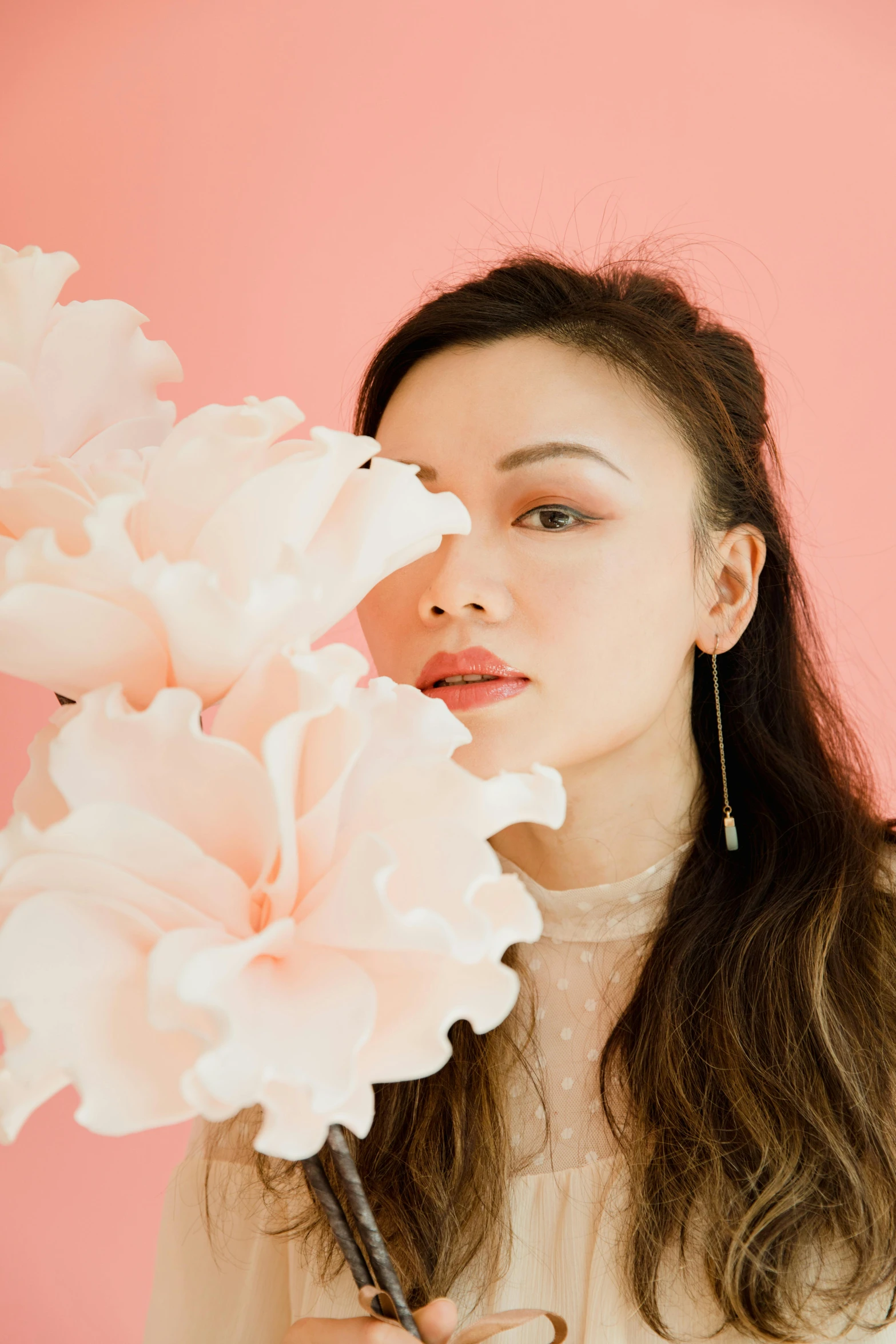 a woman holding a bunch of flowers in front of her face, an album cover, inspired by helen huang, soft blush, looking to the side off camera, portrait sophie mudd, hand on her chin
