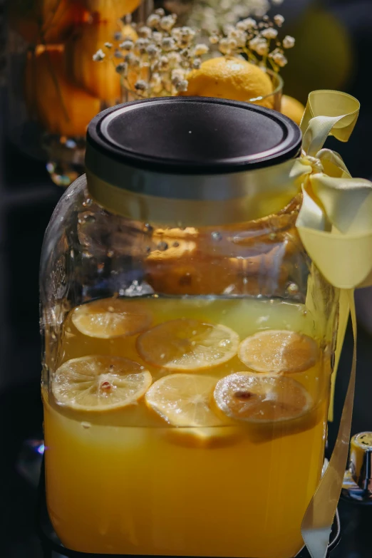 a jar of lemonade sitting on top of a table, flashing lights, orange slices, close up details, very large