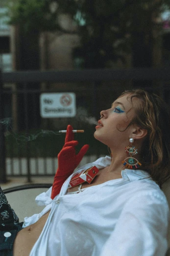 a woman sitting in a chair smoking a cigarette, inspired by Elsa Bleda, trending on pexels, renaissance, smoking outside, 80s aesthetic, sydney sweeney, cinematic outfit photo
