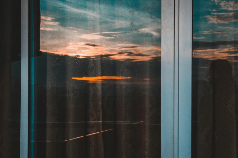 a reflection of a sunset in a window, inspired by Elsa Bleda, pexels contest winner, hotel room, high quality wallpaper, long view, glass walls