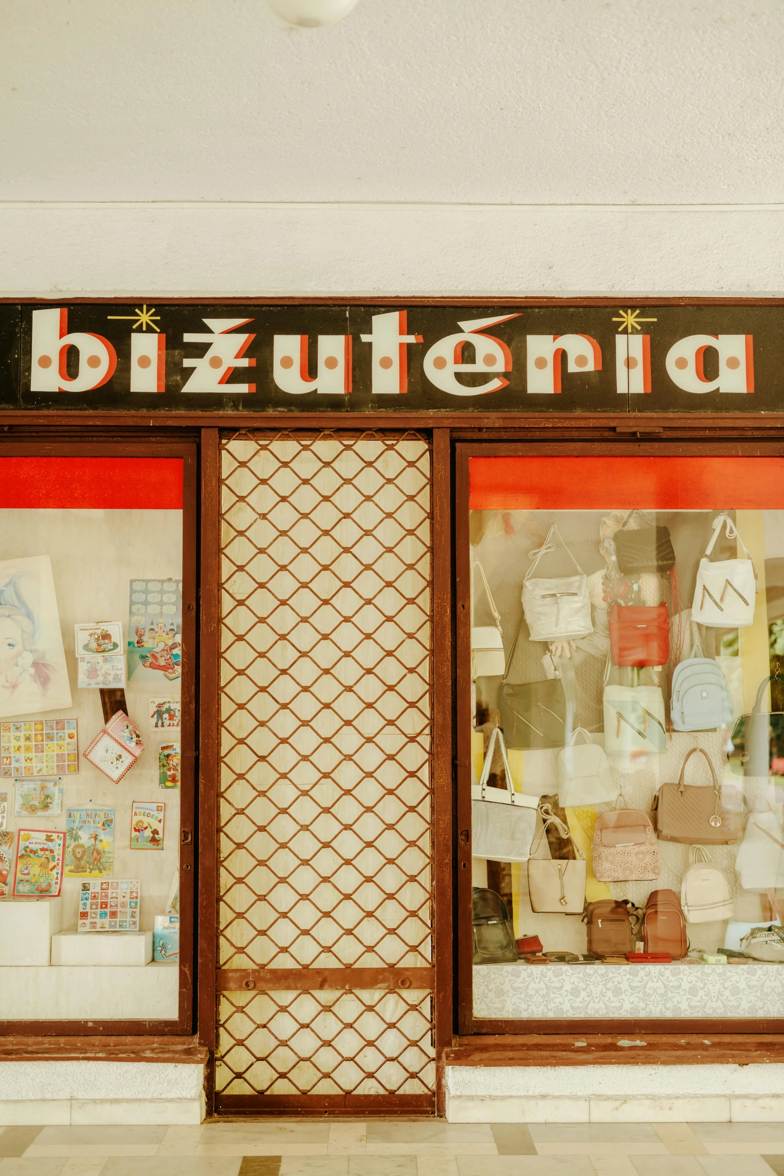 a woman sitting on a bench in front of a store, by Julia Pishtar, international typographic style, crafts and souvenirs, hungarian, bip bippadotta, inside a magical item shop