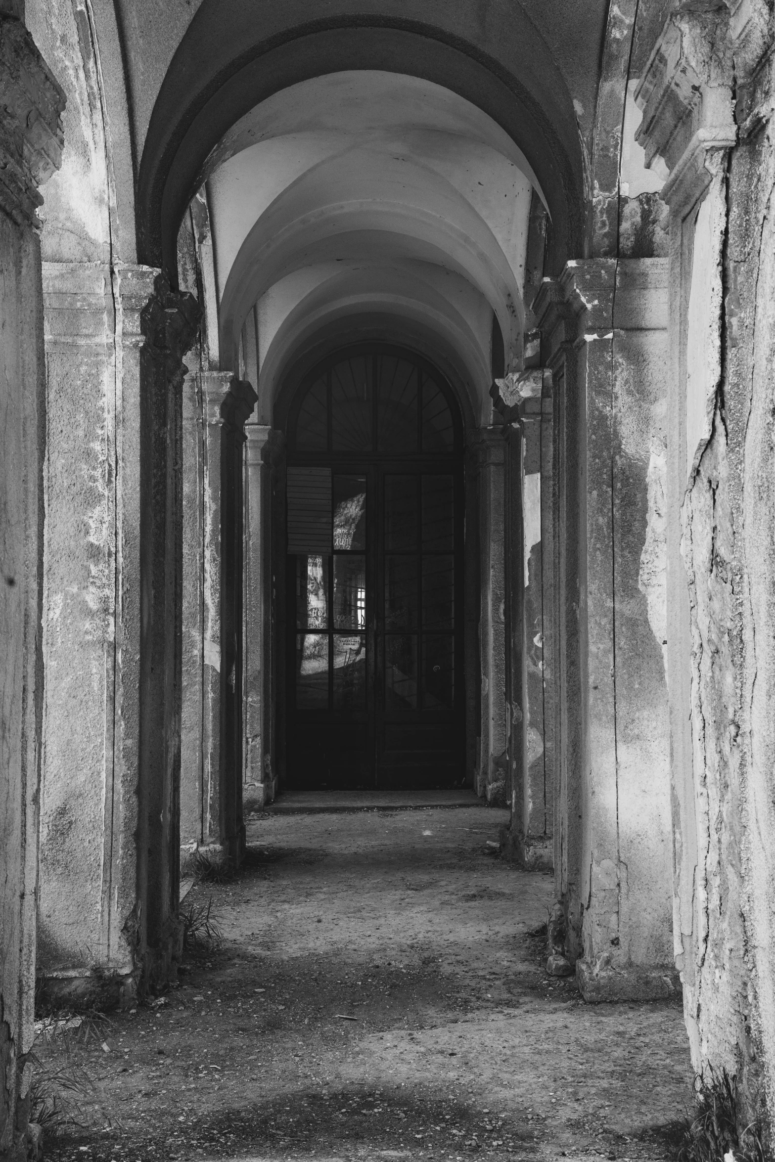 a black and white photo of a long hallway, by Alessandro Allori, baroque, deteriorated, 3 doors, ( ( photograph ) ), unknown space