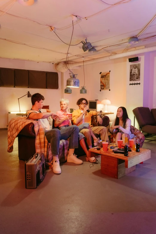 a group of people sitting on a couch in a living room, an album cover, by Jan Tengnagel, trending on pexels, capsule hotel, bisexual lighting, kpop, performing a music video