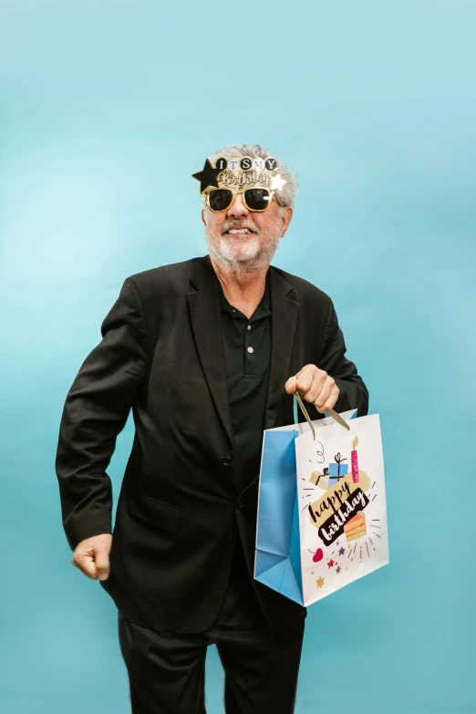 a man in a suit and sunglasses holding a bag, an album cover, pexels contest winner, gray beard, happy birthday, official store photo, wearing a bejeweled mask