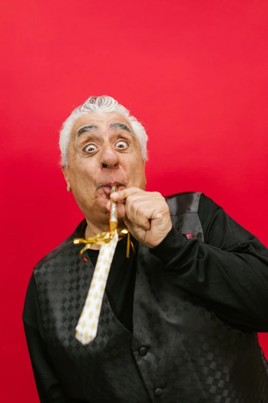 a man that has a tie in his mouth, inspired by Alexander Fedosav, holding a gold! cane!, press shot, eating cheese, ric flair