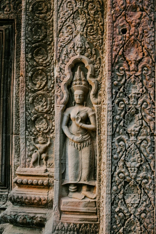a statue that is on the side of a building, angkor wat, intricate fine ornaments, inside her temple, 8 k intricate detail