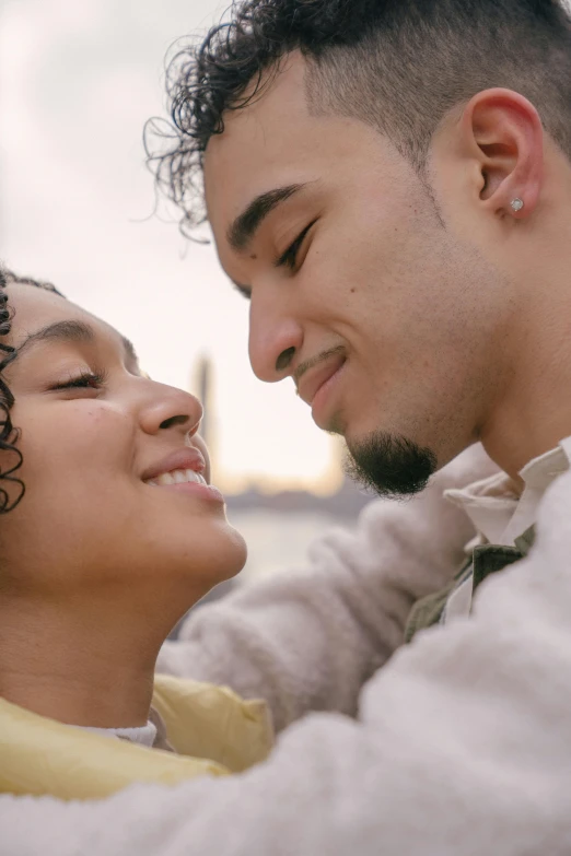 a man and a woman are looking at each other, trending on pexels, romanticism, still from a music video, light skin, curls on top, ( ( theatrical ) )