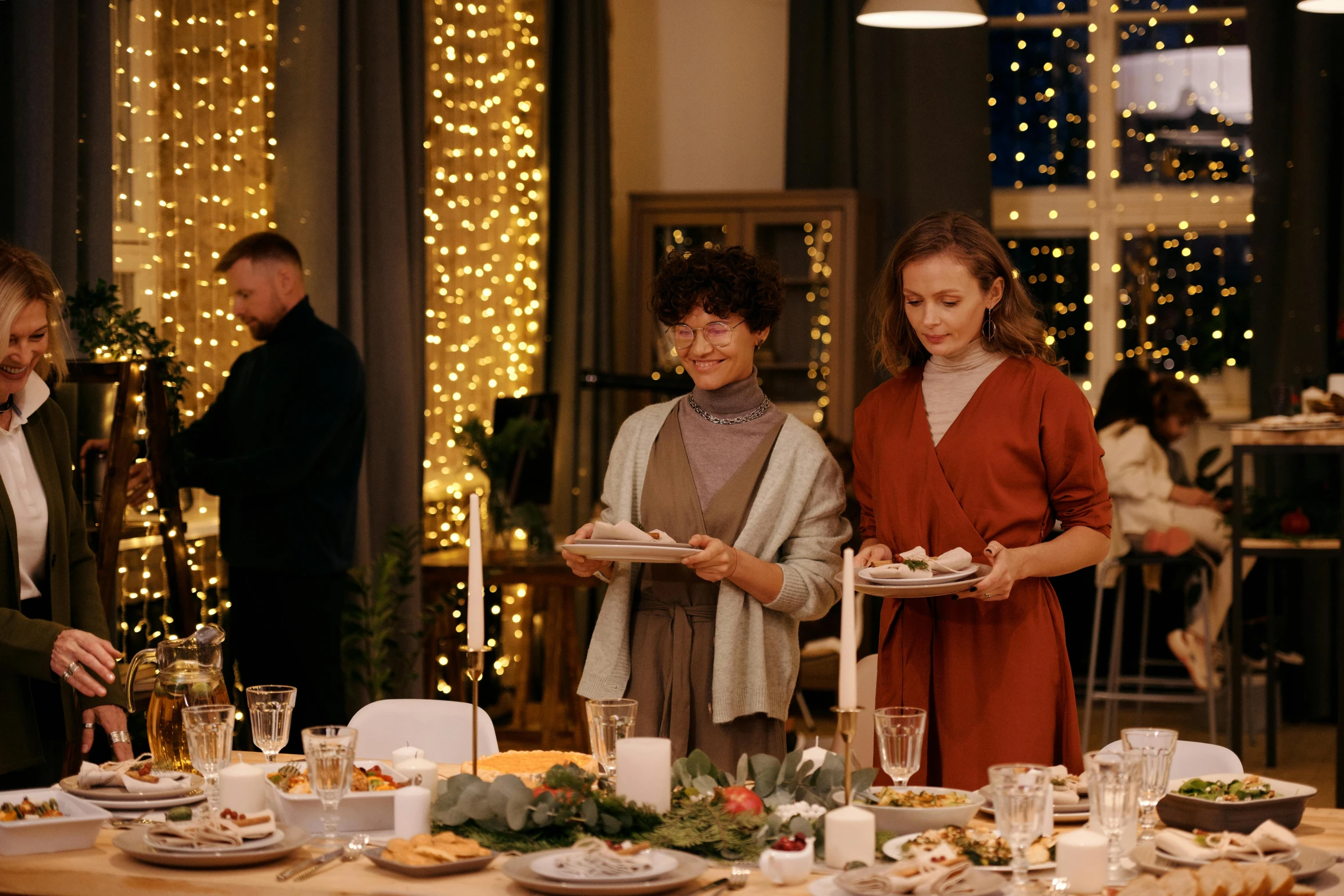 a group of people standing around a dinner table, decorations, profile image, brown, holiday season