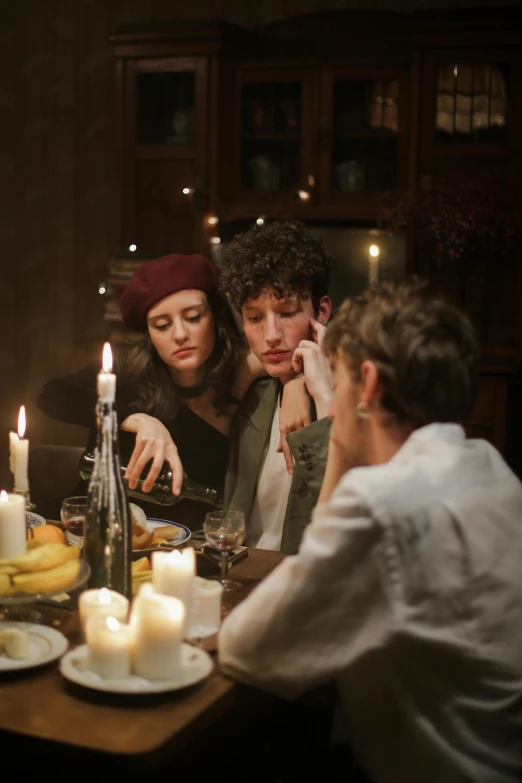 a group of people sitting around a dinner table, a portrait, trending on pexels, lesbian, candle lit, annoyed, ignant