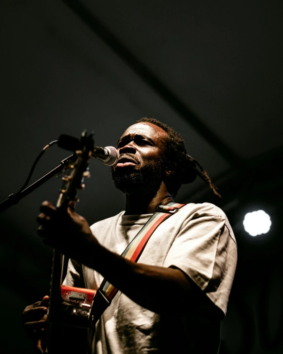 a man with dread dread dread dread dread dread dread dread dread dread dread dread dread dread dread, an album cover, by Nyuju Stumpy Brown, pexels contest winner, performing on stage, looking partly to the left, focused expression, songlines