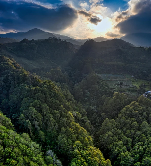 the sun shines through the clouds over the mountains, by Alejandro Obregón, unsplash contest winner, sumatraism, japan lush forest, today\'s featured photograph 4k, bird eye view, puerto rico