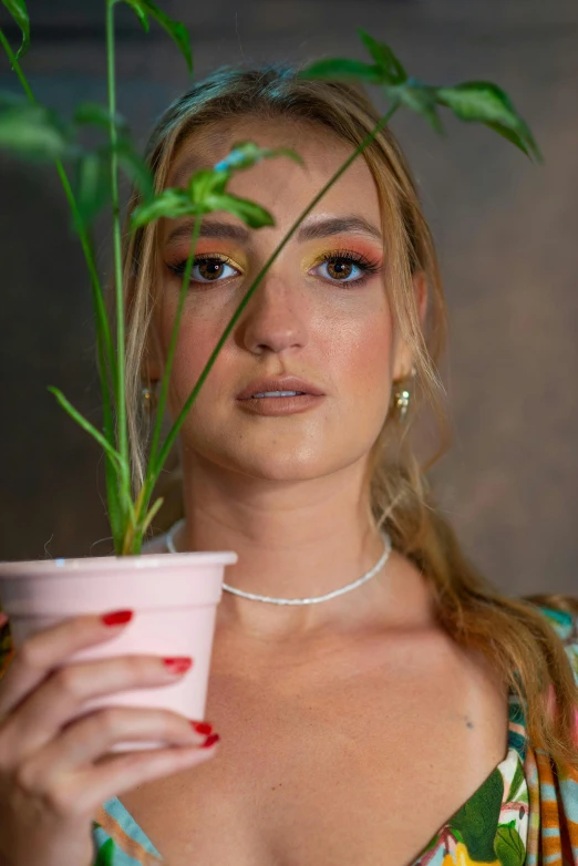 a woman holding a potted plant in front of her face, an album cover, inspired by Elsa Bleda, trending on pexels, photorealism, bella thorne, closeup headshot portrait, 🌺 cgsociety, princess of cannabis