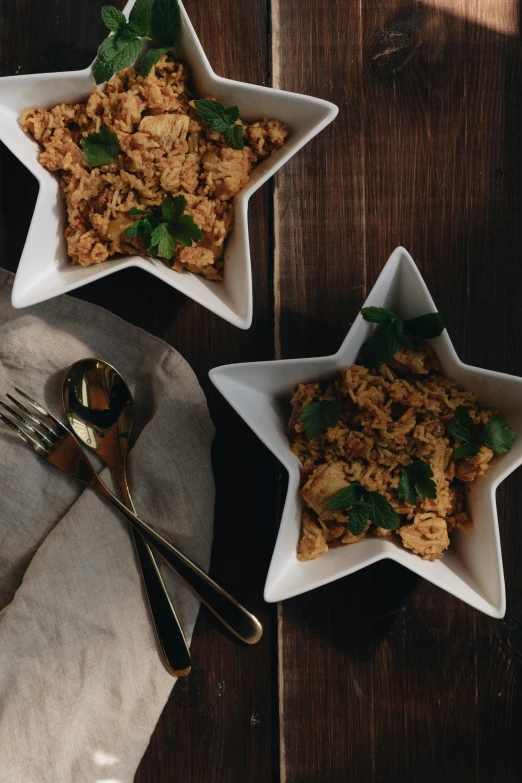 three bowls of food sitting on top of a wooden table, stars, chicken, thumbnail, rice