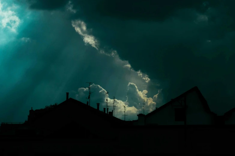 a dark sky filled with lots of clouds, inspired by Elsa Bleda, pexels contest winner, magical realism, light breaks through the roofs, teal sky, crepuscular ray, dark neighborhood