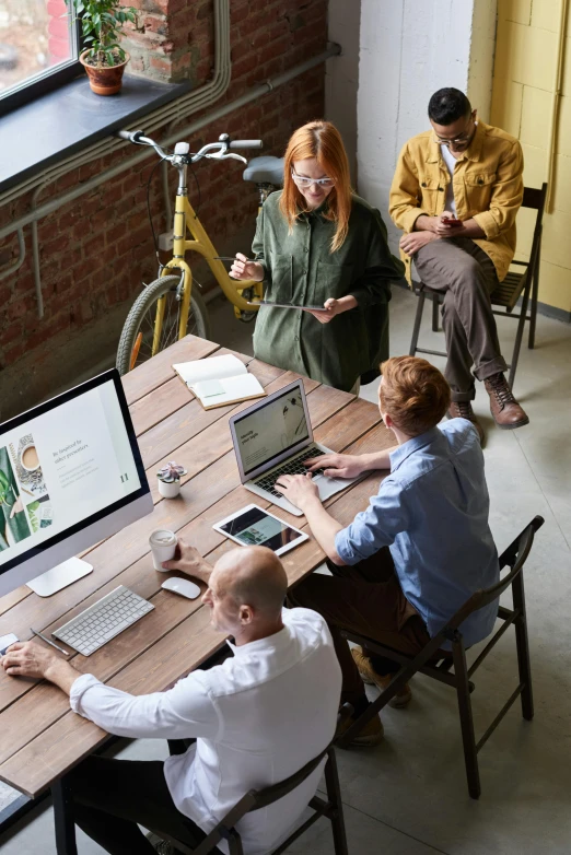 a group of people sitting around a wooden table, a digital rendering, trending on pexels, excel running on the computer, maintenance, vertical orientation, ecommerce photograph