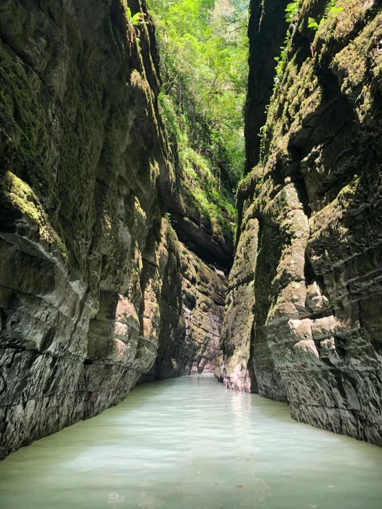 a man standing in the middle of a river in a canyon, deep chasm, 2022 photograph, taiwan, puerto rico