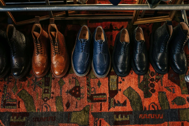 a row of shoes sitting on top of a rug, renaissance, deus ex machina, chesterfield, blue - print, wide overhead shot