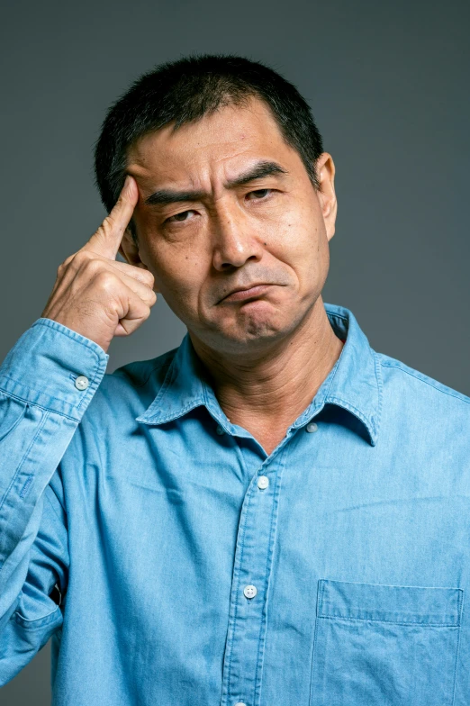 a man in a blue shirt holding his hand to his forehead, a stock photo, trending on reddit, shin hanga, ernie chan, pouting, plain background, ethnicity : japanese