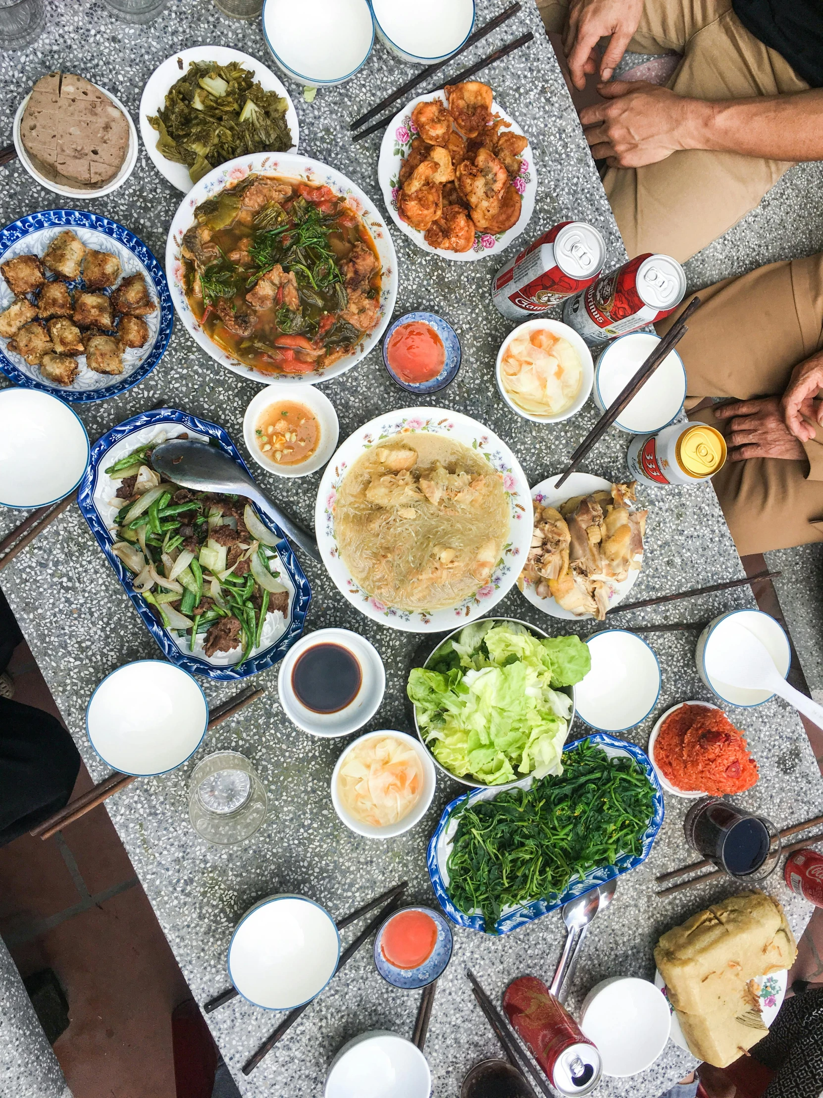 a group of people sitting around a table full of food, guangjian, profile image