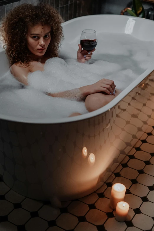 a woman sitting in a bathtub with a glass of wine, trending on pexels, renaissance, ethereal bubbles, extremely moody, curls, mid night