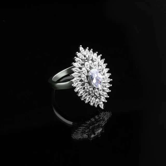 a diamond ring on a black surface, inspired by L. A. Ring, pixabay, commercial product photography, dramatic lighting !n-9, floral bling, silver jewelry