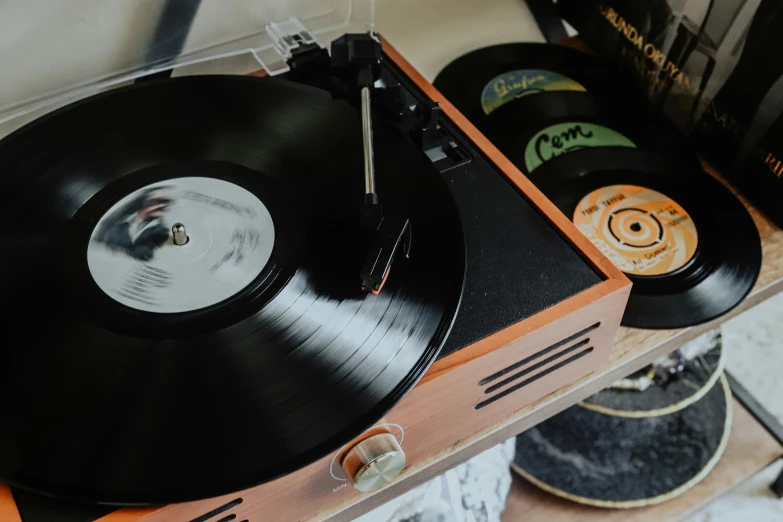 a record player sitting on top of a wooden table